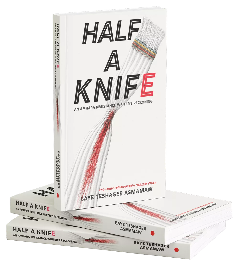 Three copies of Half a Knife: An Amhara Resistance Writer’s Reckoning by Baye Teshager Asmamaw — one standing upright on two lying flat. The cover sets the title in tall outlined capitals on warm white, the final letter in red, beside a ceremonial fly-whisk whose strands are stained red down the middle.